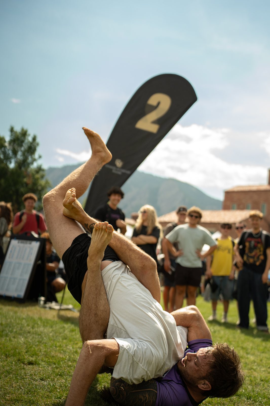 A competitor working for a submission on grass